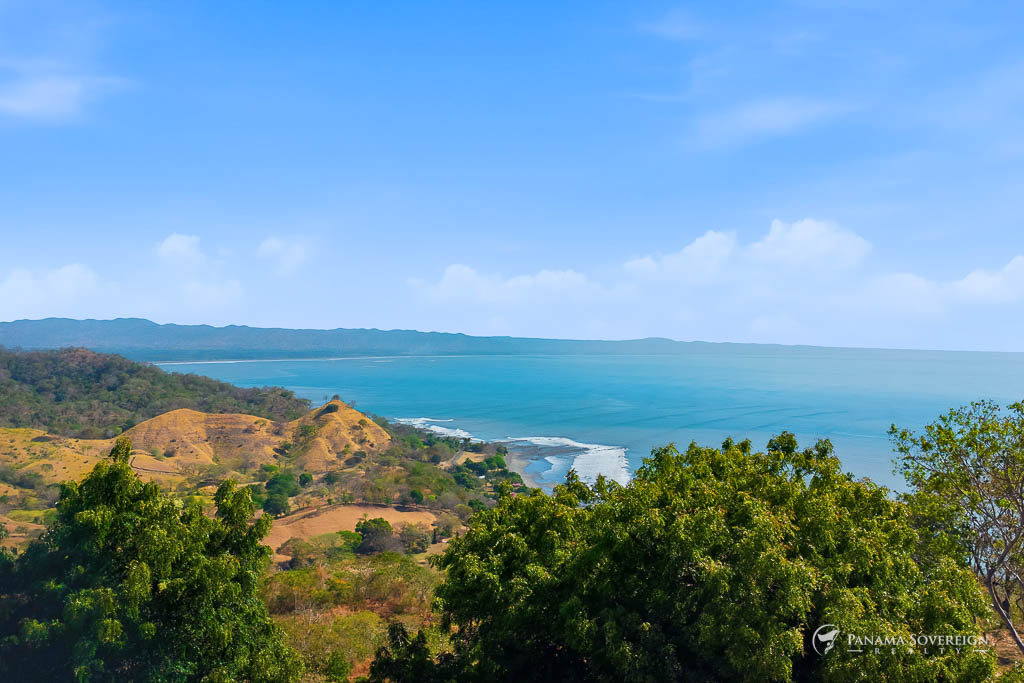 Panoramic coastline and ocean view from elevated hillside overlooking Bucaro Panama beach and surrounding landscape