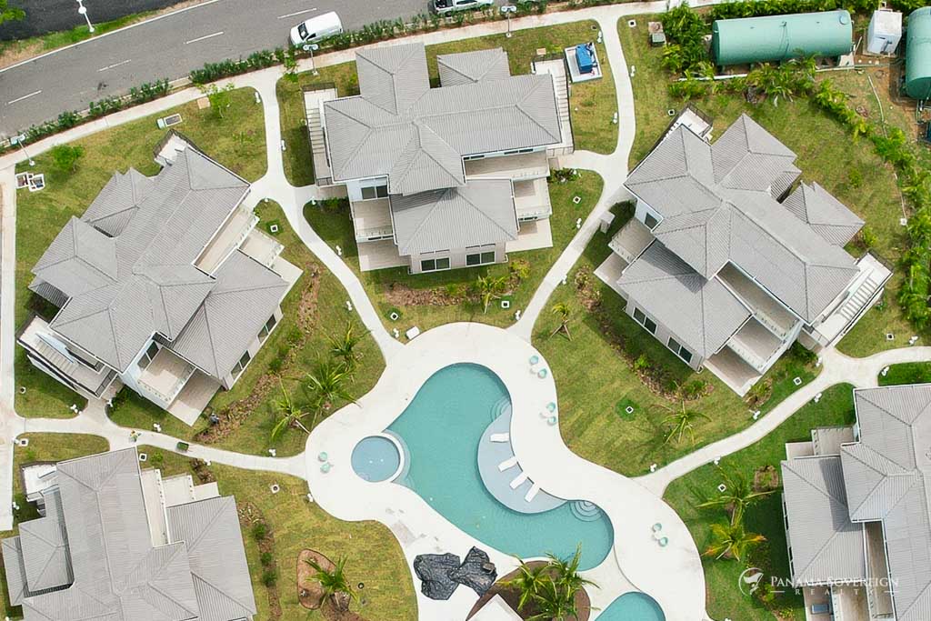 Aerial view of the Brisas del Mar residential complex showing the circular pool and landscaped central courtyard.
