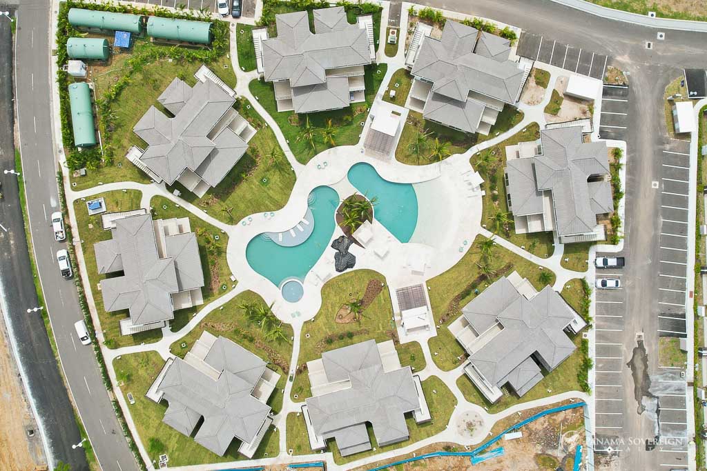Overhead image highlighting the arrangement of low-rise buildings around the main pool area.