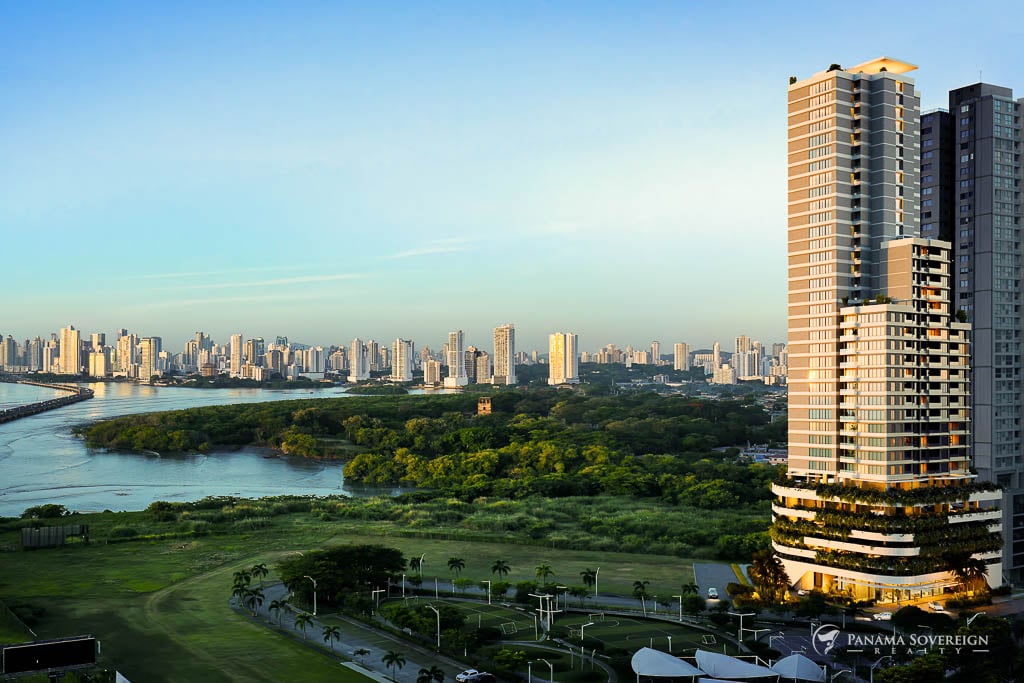 Daytime view of high-rise residential buildings overlooking green spaces and the ocean in Costa del Este.