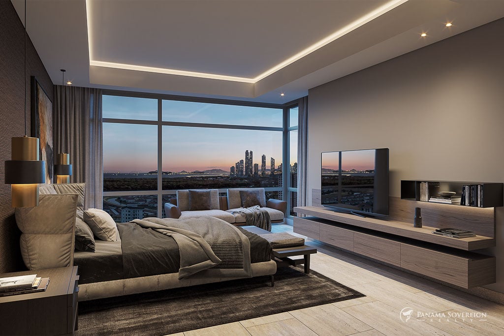 Bedroom with a panoramic city view, featuring a comfortable bed, entertainment center, and warm lighting for a cozy atmosphere.